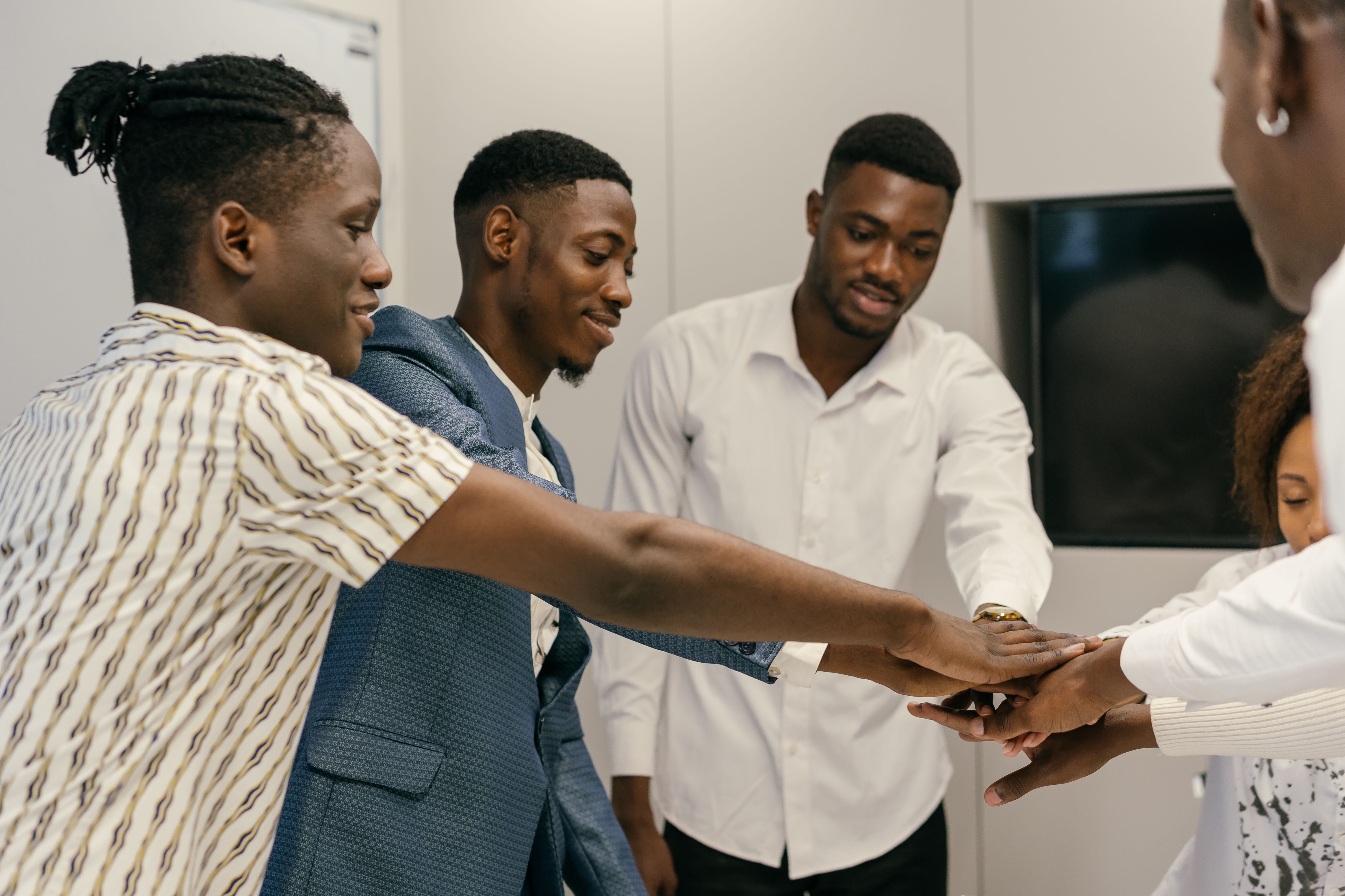 A diverse team of professionals smiling together in a modern workplace